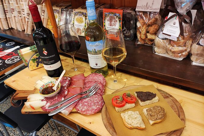 Siena walking tour with lunch & Chianti wine - Piazza Tolomei: historic cafés, alleys, and contrada flavor
